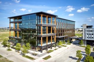 Image shows a building and parking lot.