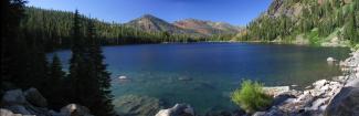 Mountain lake with forested hills in the background