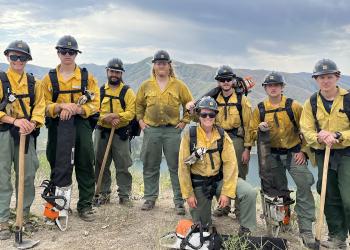 Crew 412 firefighters grouped on hilltop with tools