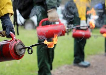 Drip Torches held by firefighters