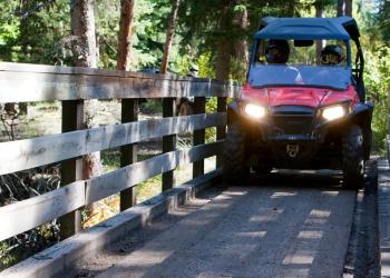 OHV crosses bridge
