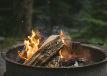 Wood fire burning in iron fire ring.