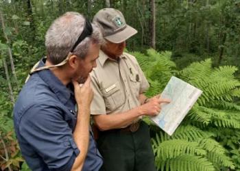 A wilderness ranger talking to a camper