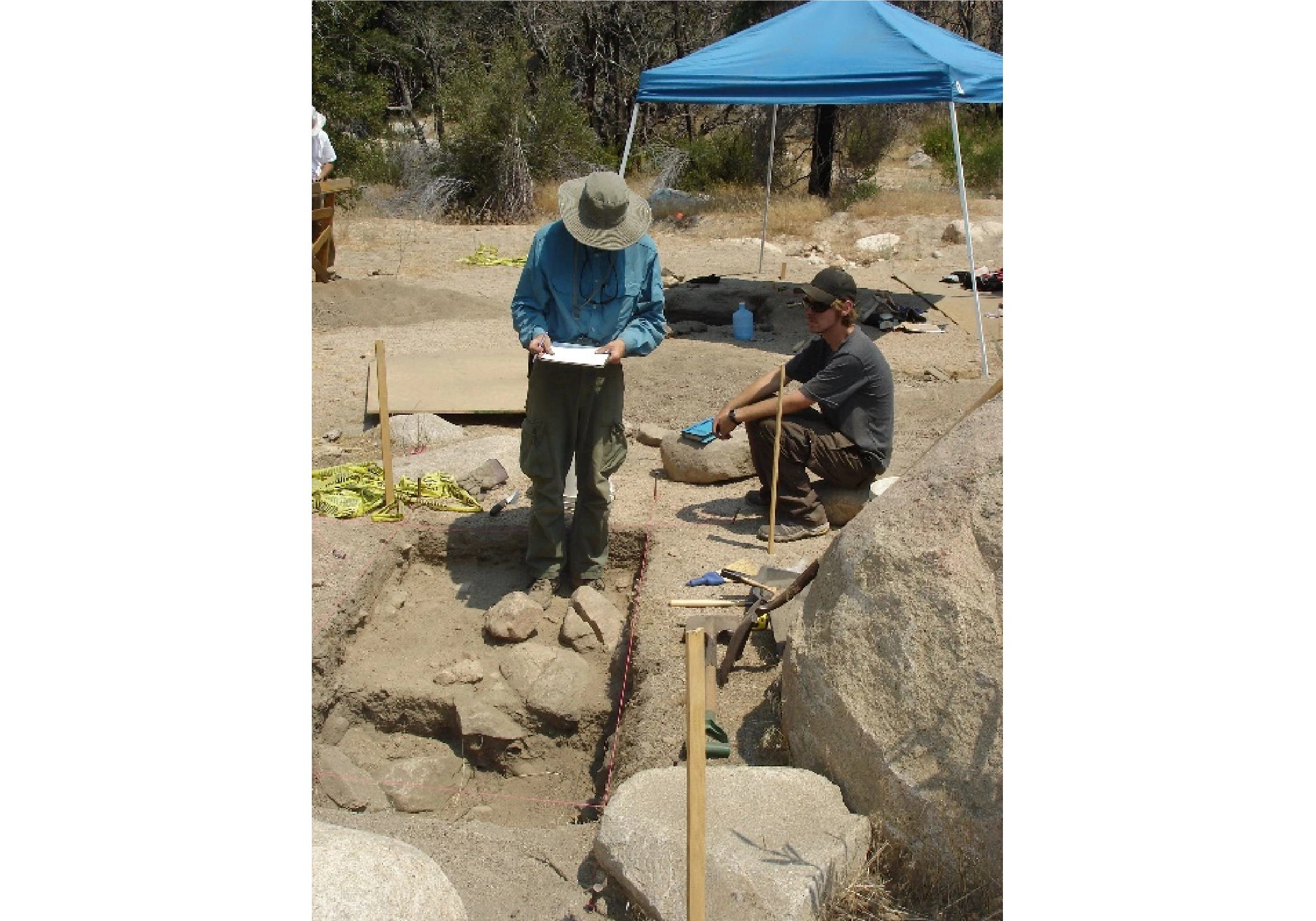 Two Archaeology Field Students survey a site