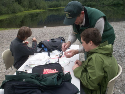 Doug Jones teaches students at the Crystal Lake Day Camp the art of fly tying.