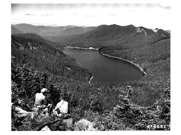 John Todd, Mt. Hood forest officer and E. Peffer, R-6 Information Specialist (Left to right), surveying Bull Run Lake from Hiyu Mountain. This lake is the uppermost storage basis for the City of PortlandÕs water supply.