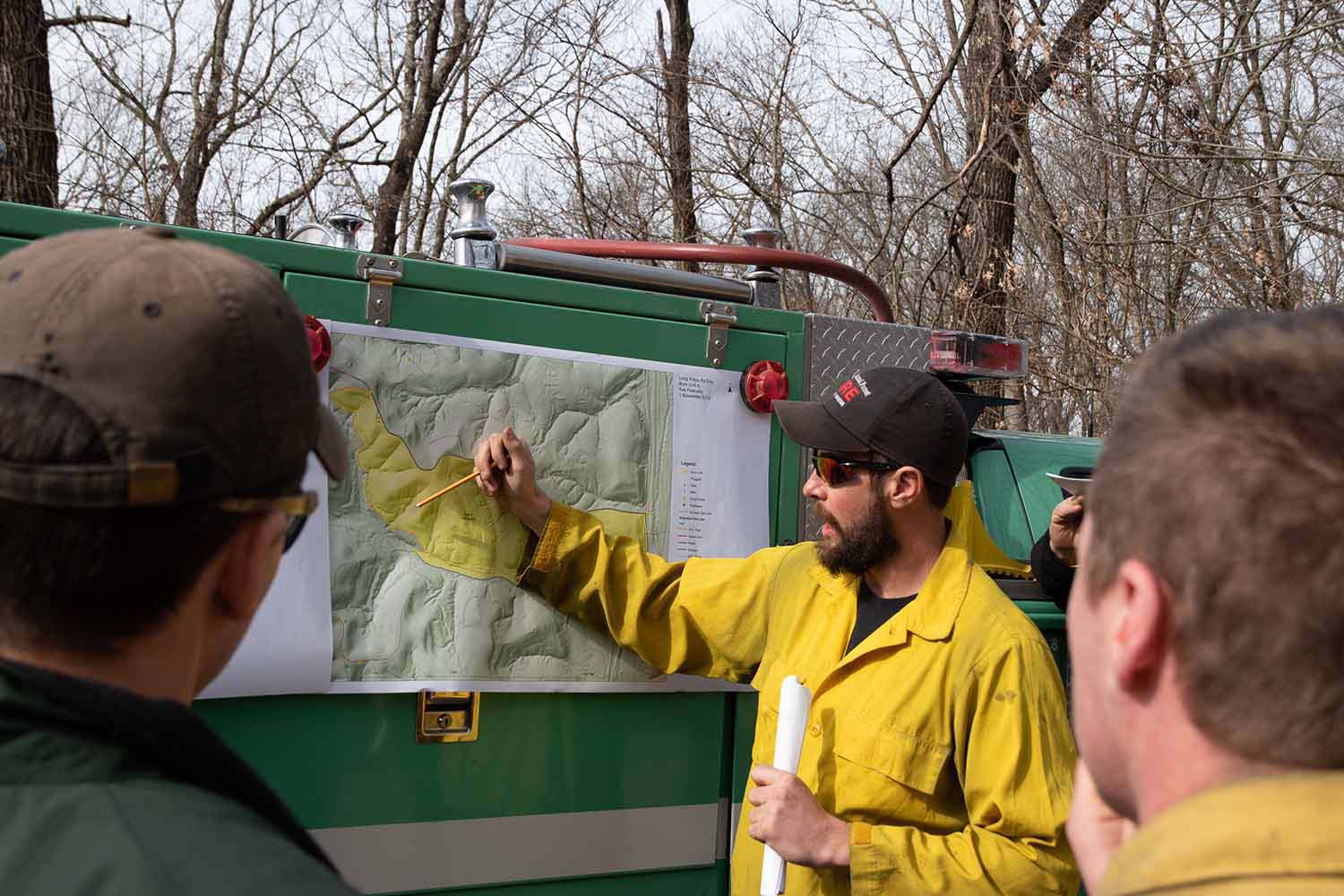 A team of USDA Forest Service employees review a map as part of prescribed burn planning.