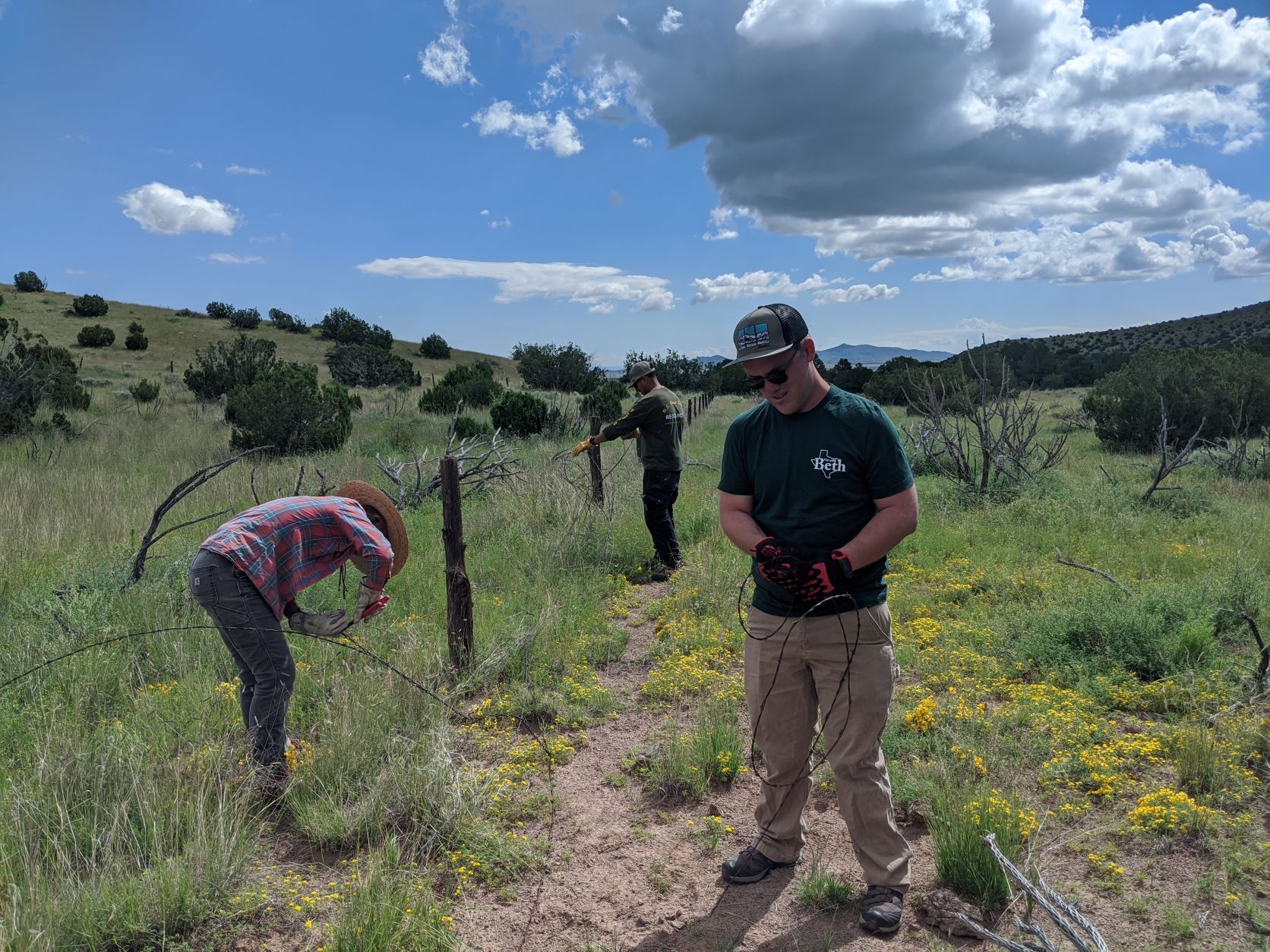 Volunteers repair fencing on the Magdalena Ranger District