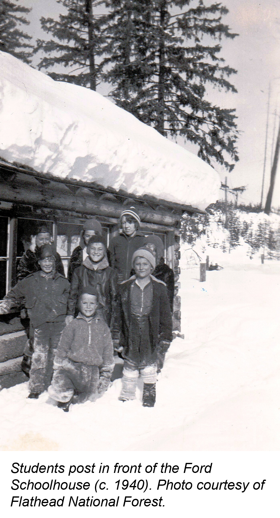 A group of Ford Schoolhouse students gathers outside in front of the snow-covered school (1940)