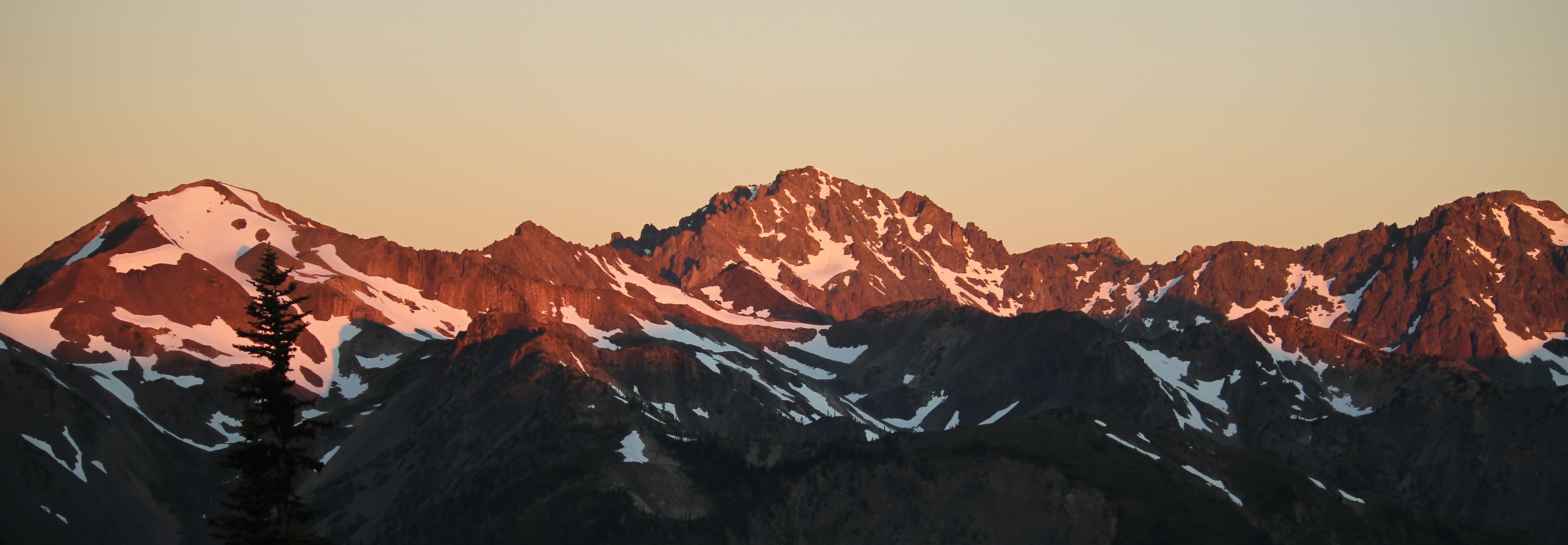 Jagged, snow capped peaks at sunset