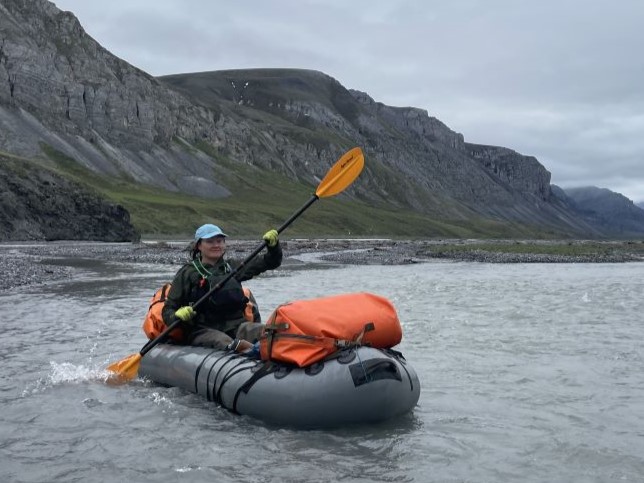 Tessa Hulls paddles in a packraft among mountains in the arctic refuge.