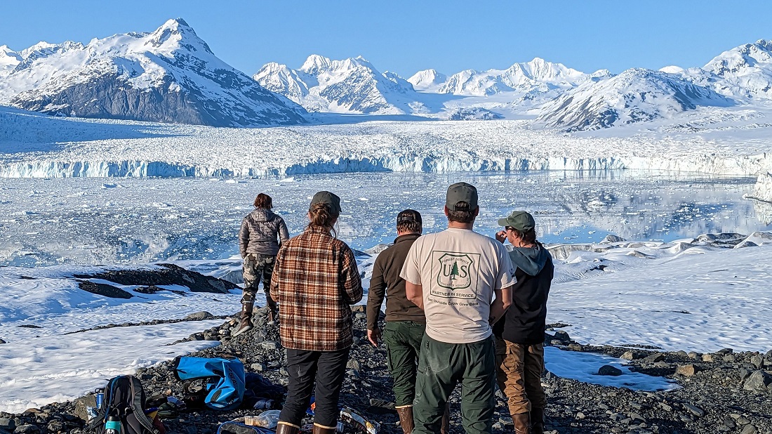 Glacier Ranger District employees view the face of Columbia Glacier from an overlook.