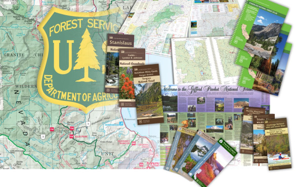 A photo of a map with the Forest Service shield overlayed and hard copy maps layed on top