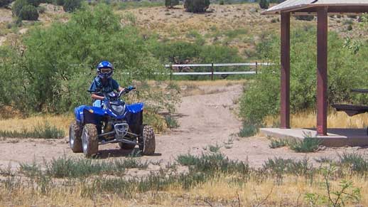 Child riding ATV in the tot lot at Hayfield Draw OHV Area