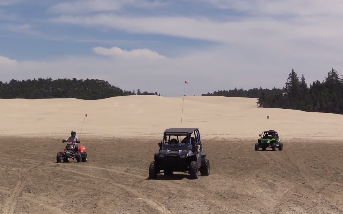 Three Off Road Vehicles on the Sand
