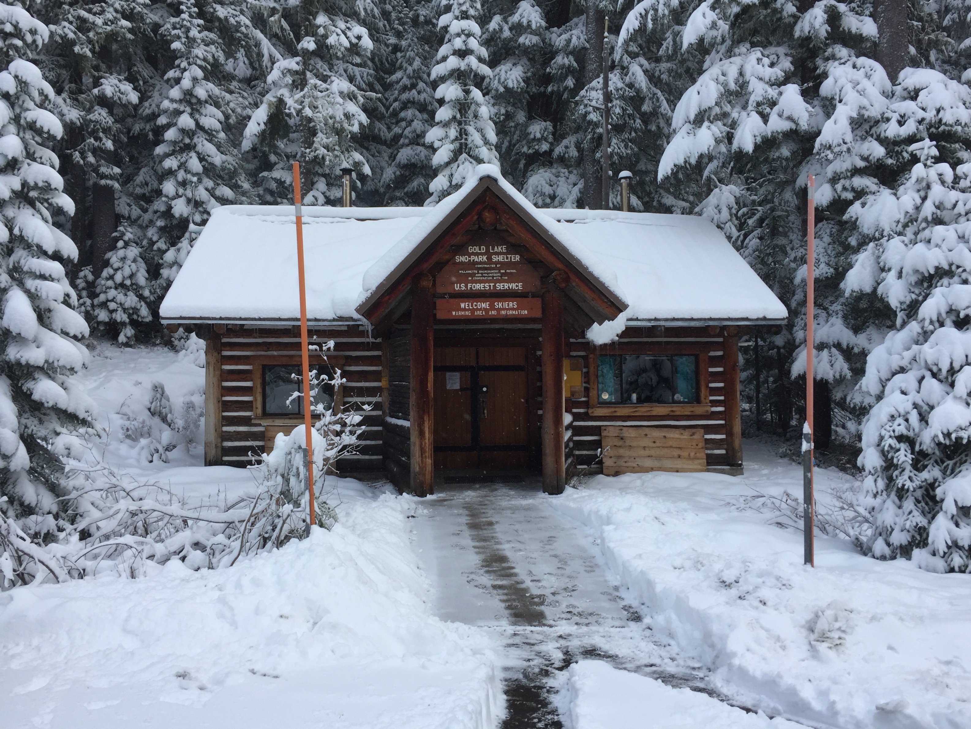 Gold Lake Sno Park Warming Hut / Backcountry Patrol Cabin in early winter with snow