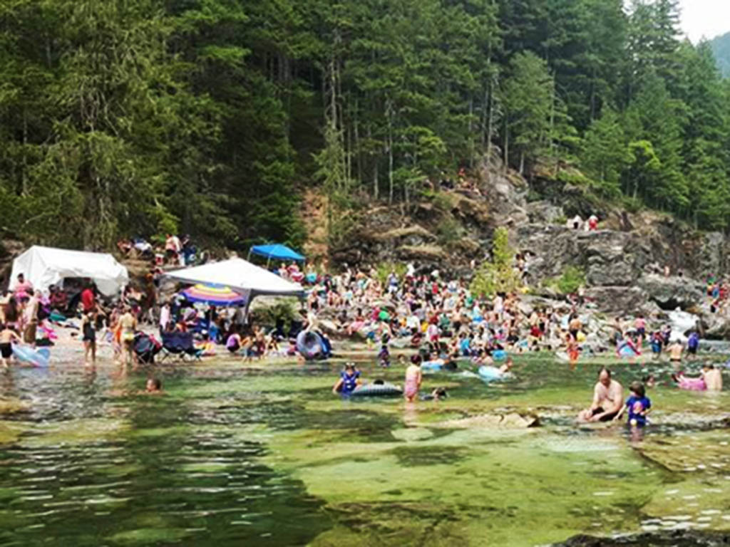 Large crowds in the water and on the shore at Three Pools Day Use Area