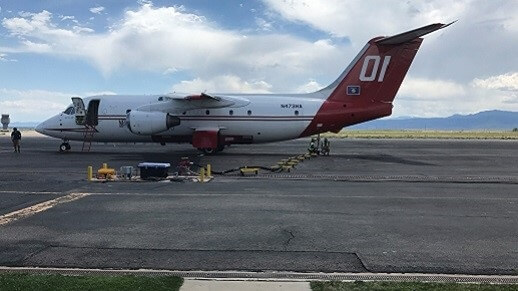  Workers loading a BA-146 airtanker in pit 1.