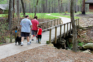 A family enjoys a walk at Boykin Springs Recreation Area in the Angeling National Forest.