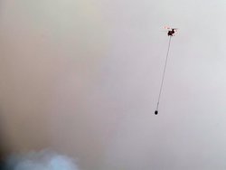 Tinder fire: helicopter with bucket against a smokey background