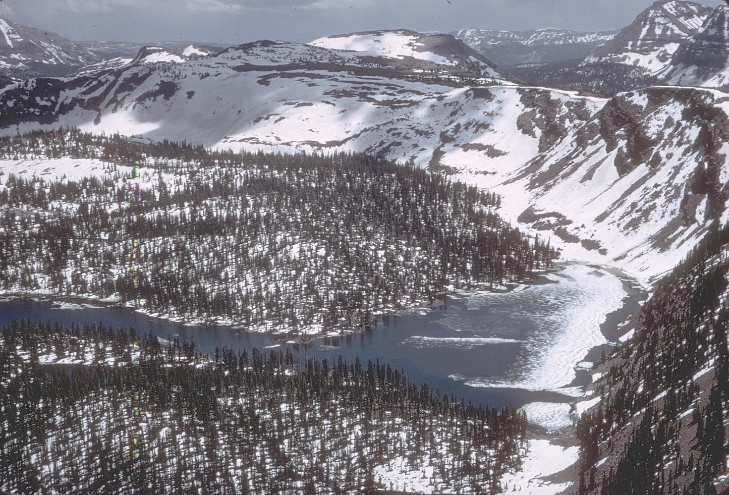 Photo depicting a high mountain basin with a lake in the High Uintas Wildrness in Winter