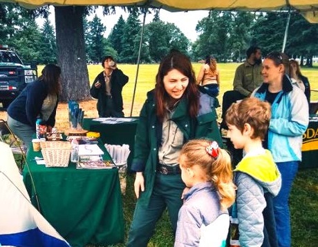 Rangers talk woth kids about the outdoors at an event.
