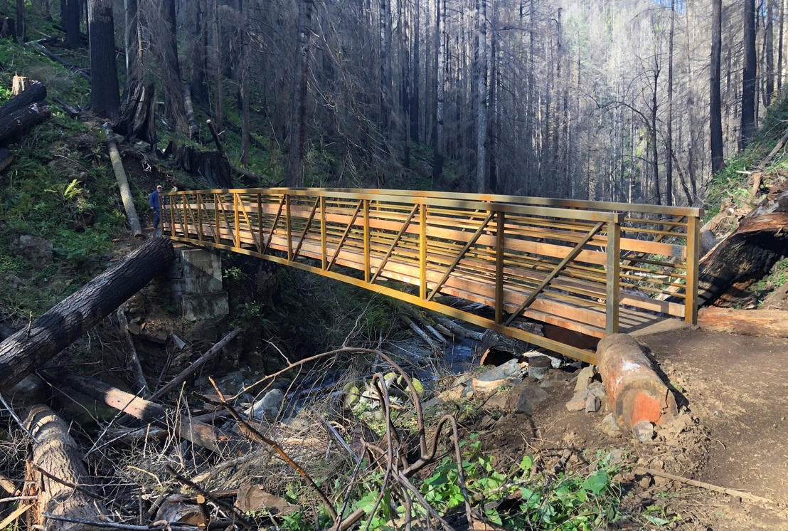 New wood bridge along Larch Mountain Trail spans a large creek.