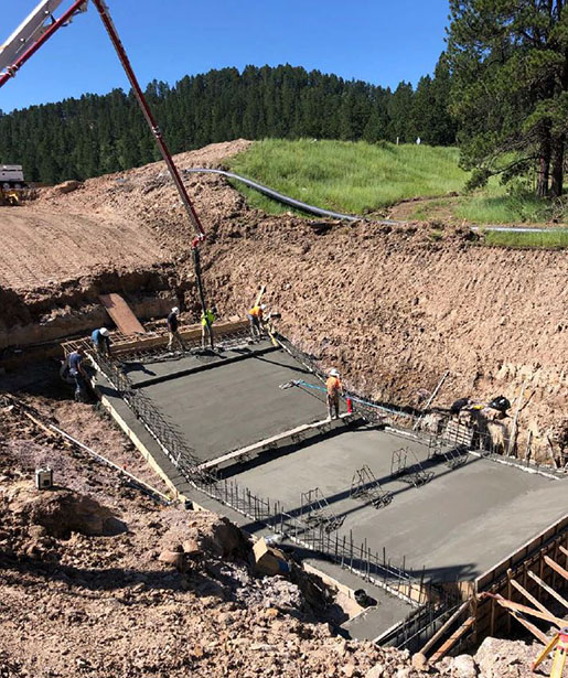 Image of workers placing concrete for new spillway slab 