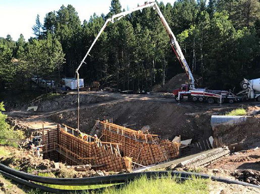 Image of concrete being placed into wall forms