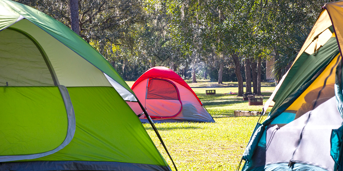 Campground with three tents very close to the photographer.