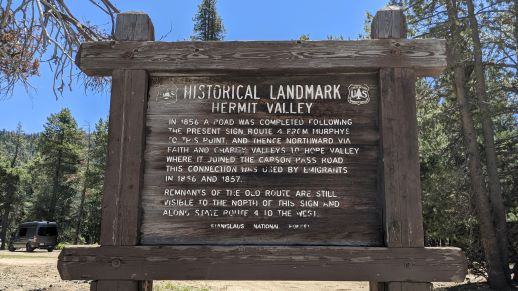 Wooden sign with historical information about Hermit Valley