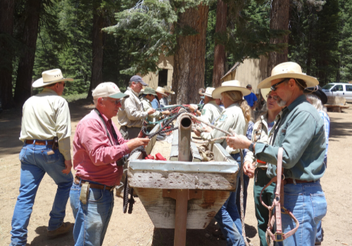 A small group of packers learn how to tie knots in ropes