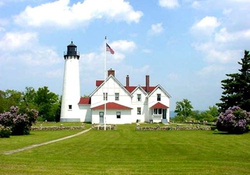 white lighthouse tower and innkeeper quarters