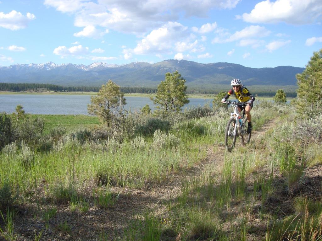 Woman riding mountain bike along Phillips Lake trail