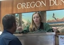 Forest Service staff giving information to visitor at the Oregon Dunes Visitor Center