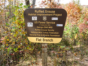 A brown and yellow sign describes project and the partners that worked together.
