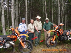 Cutting the grand opening ribbon for Moss Lake Motorcycle Trail.