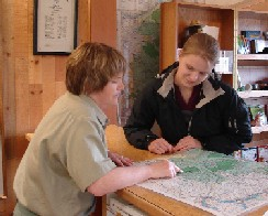 Visitor support services volunteer with map