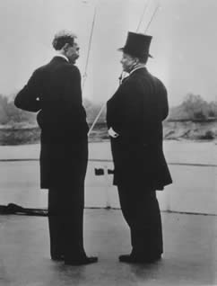 President Theodore Roosevelt and Gifford Pinchot, the first chief of the Forest Service, standing talking to each other.