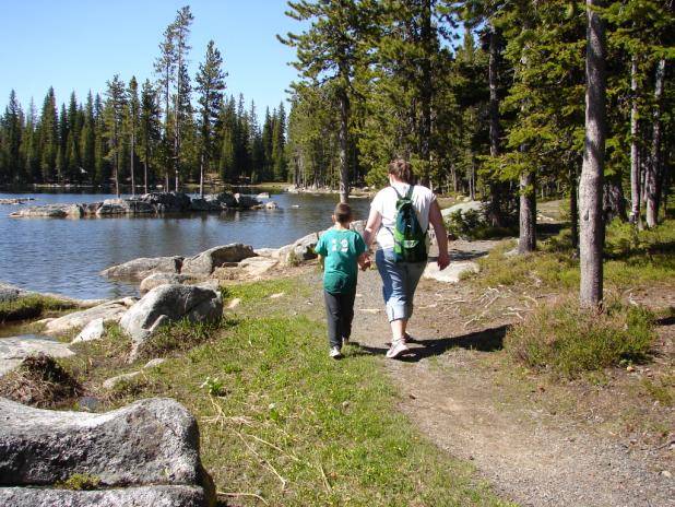 Teenage girl and small boy hiking a trail along Anthony Lake