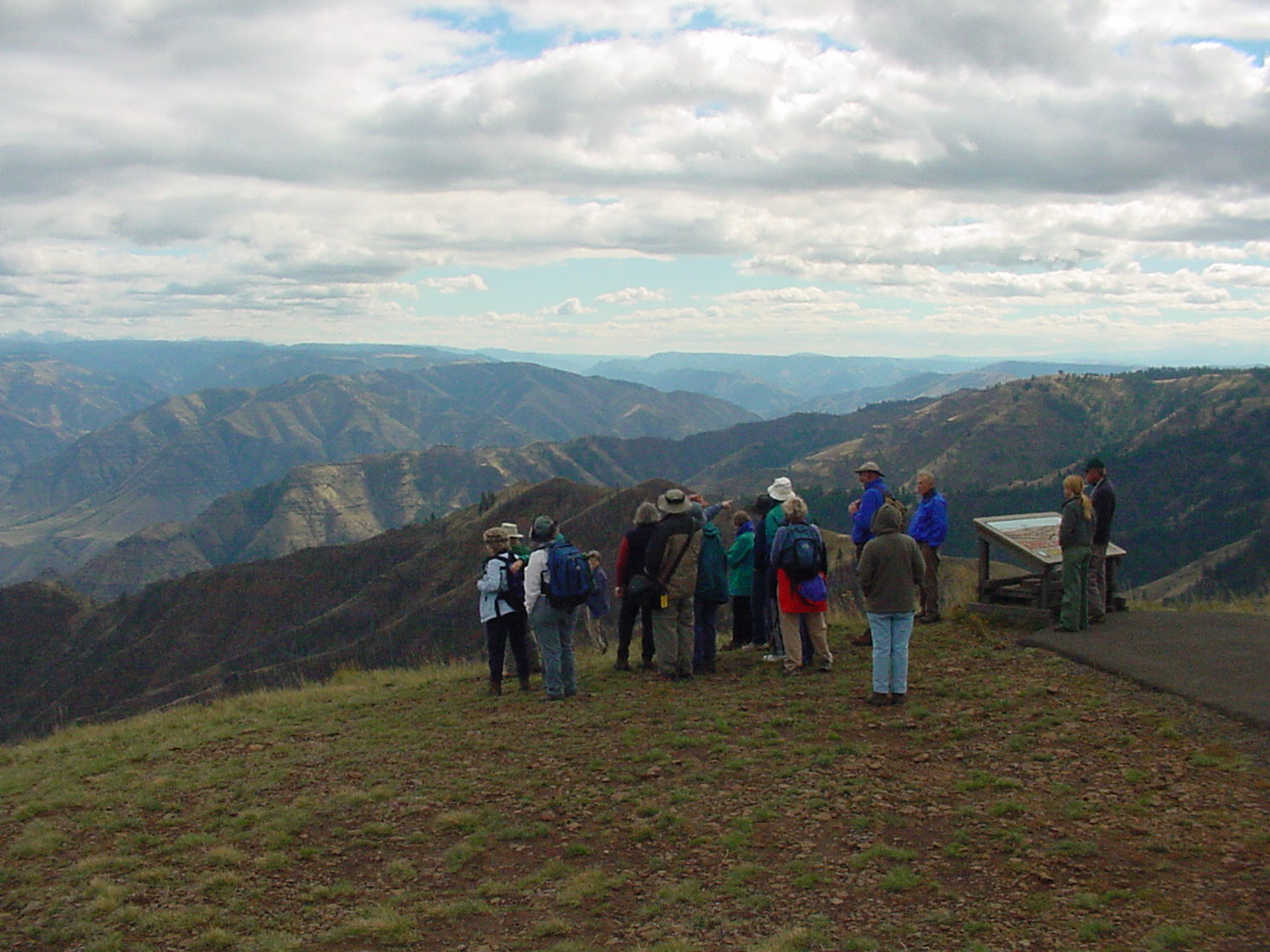 Large group overlooking open canyon and grassy slopes