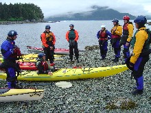 A group of kayakers gives a safety talk before setting out.