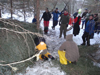 Training participants learning to build winter shelters