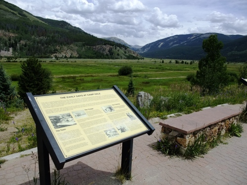 picture of interpretive sign with Camp Hale in background