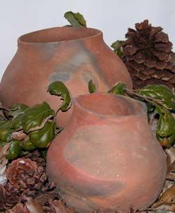 Photo of two brown colored clay pots