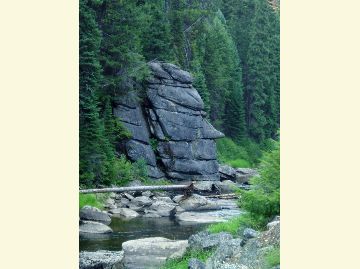 Large rocks on the river in the shape of a facial profile