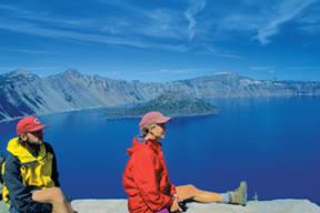 two hikers looking at Crater Lake, OR