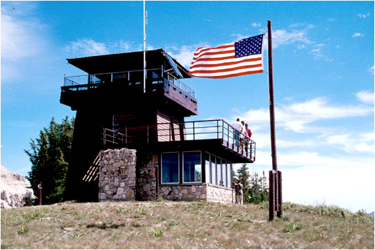 Photo of the Clay Butte Lookout and an American flag