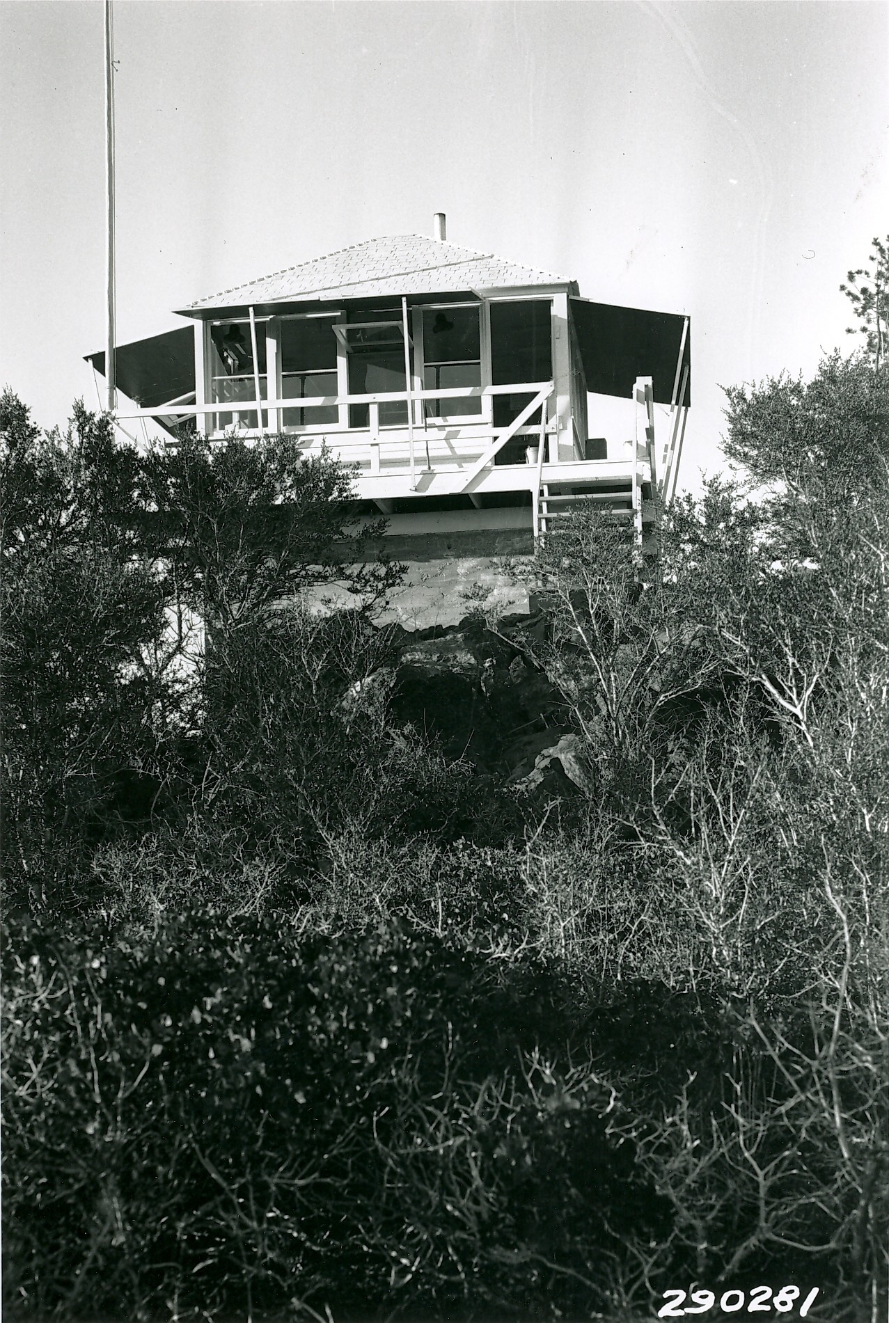 An old wooden lookout on a rock base.