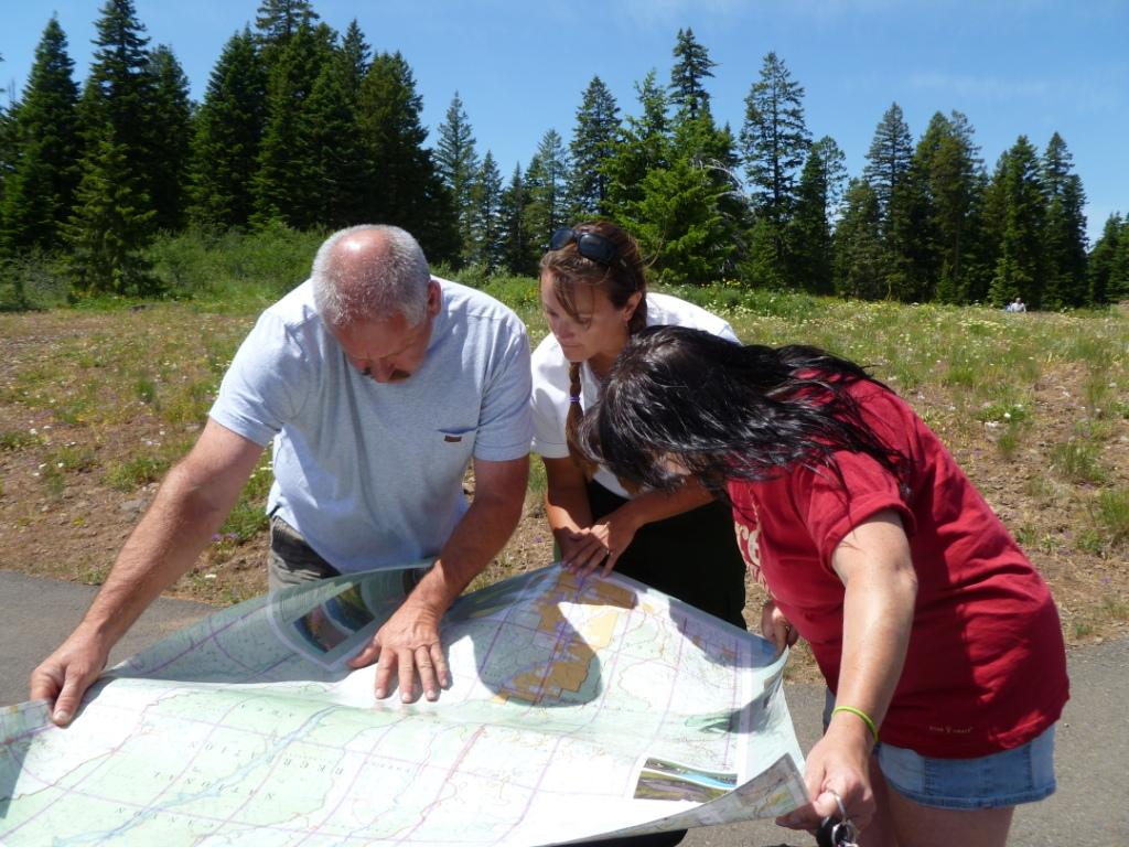 Forest Service employee helping visitors with a map